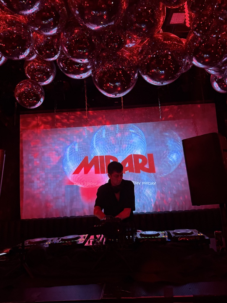 Mathéos on the decks beneath a ceiling of red-lit disco balls